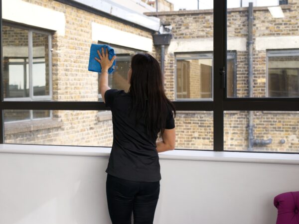 A NuServe operative cleaning windows.